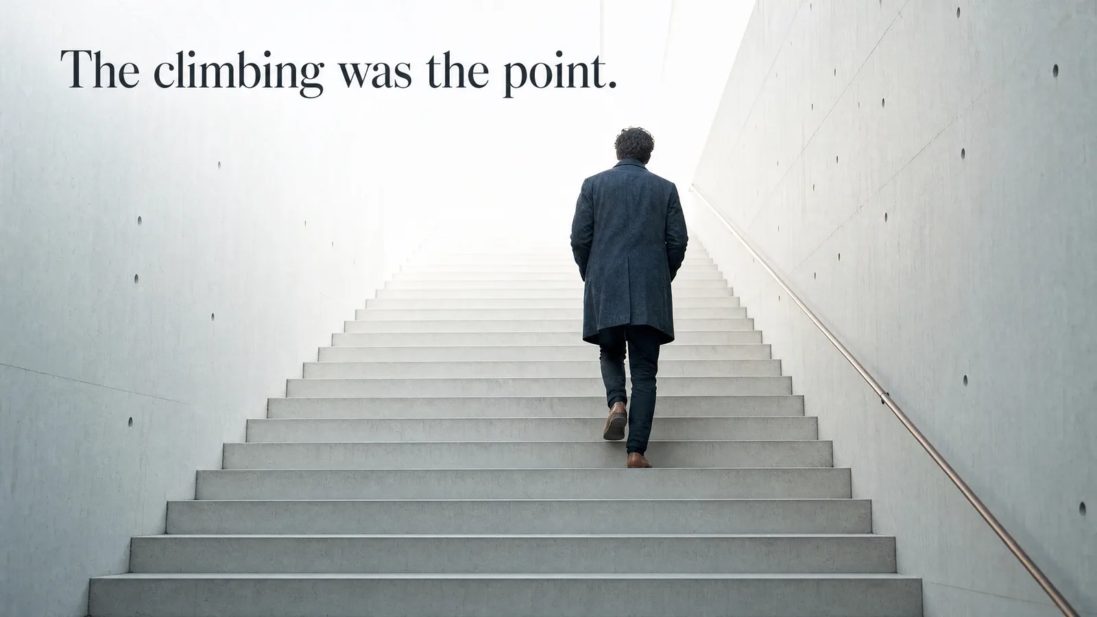 Slide: The climbing was the point. A man in a long coat climbing a concrete staircase toward the light.